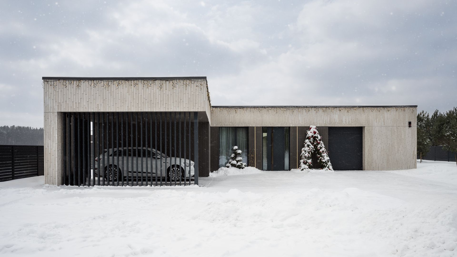 Modern concrete home with car in a gated garage, covered in snow; cloudy sky.