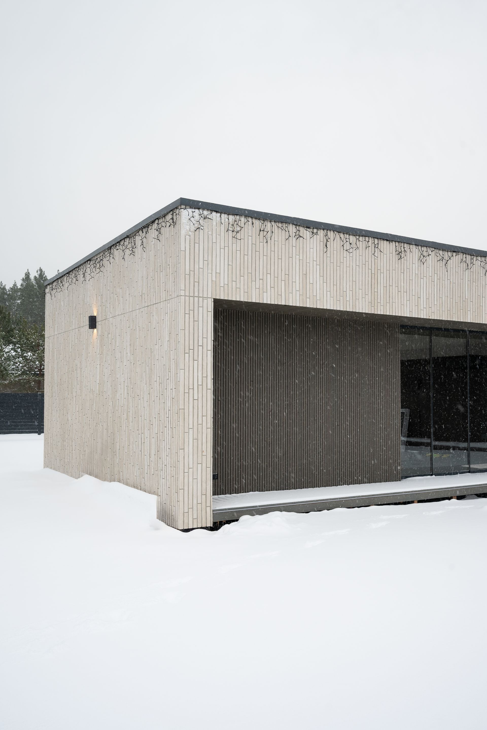 Modern concrete building with a snow-covered exterior.