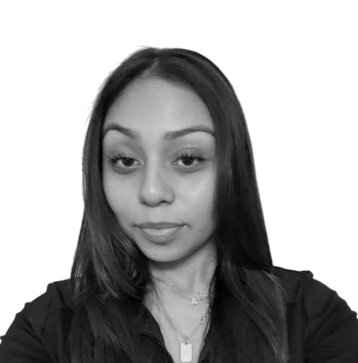 Black-and-white portrait of a person with long hair, facing forward against a plain background.