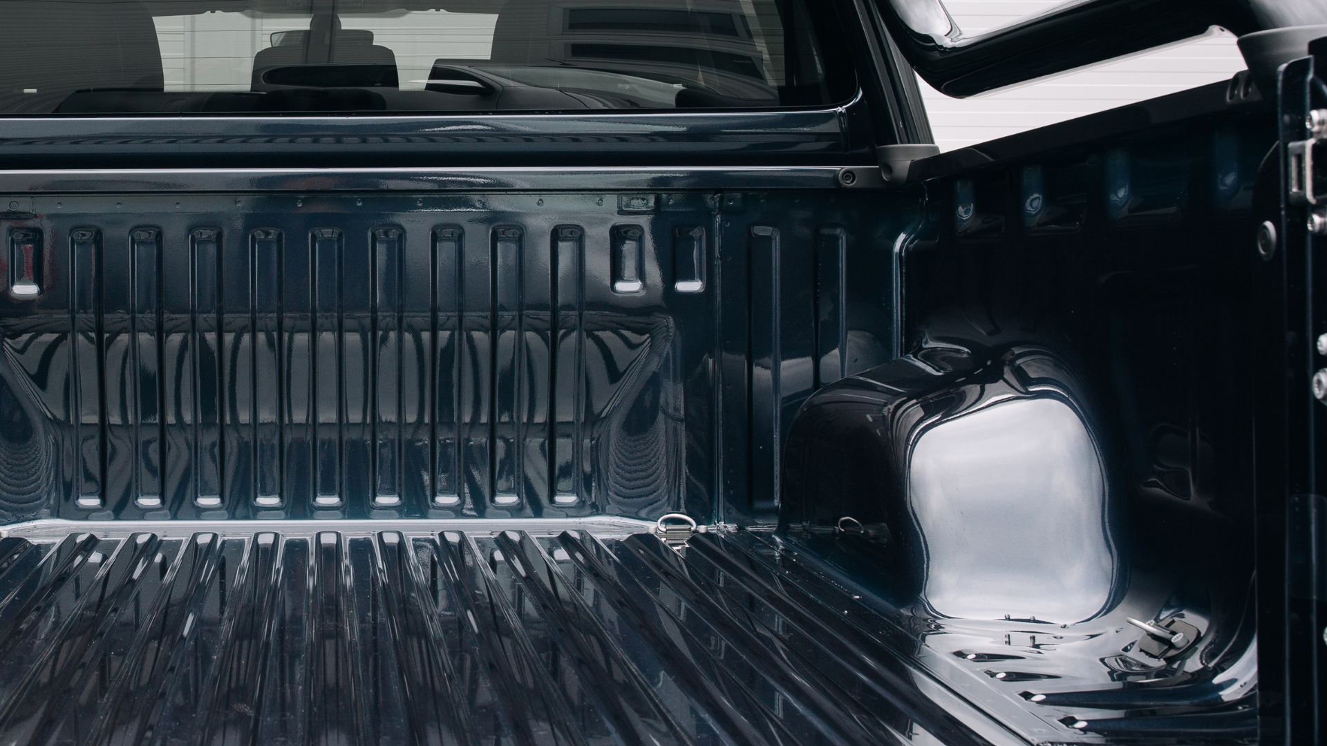 A close up of the back of a black truck.