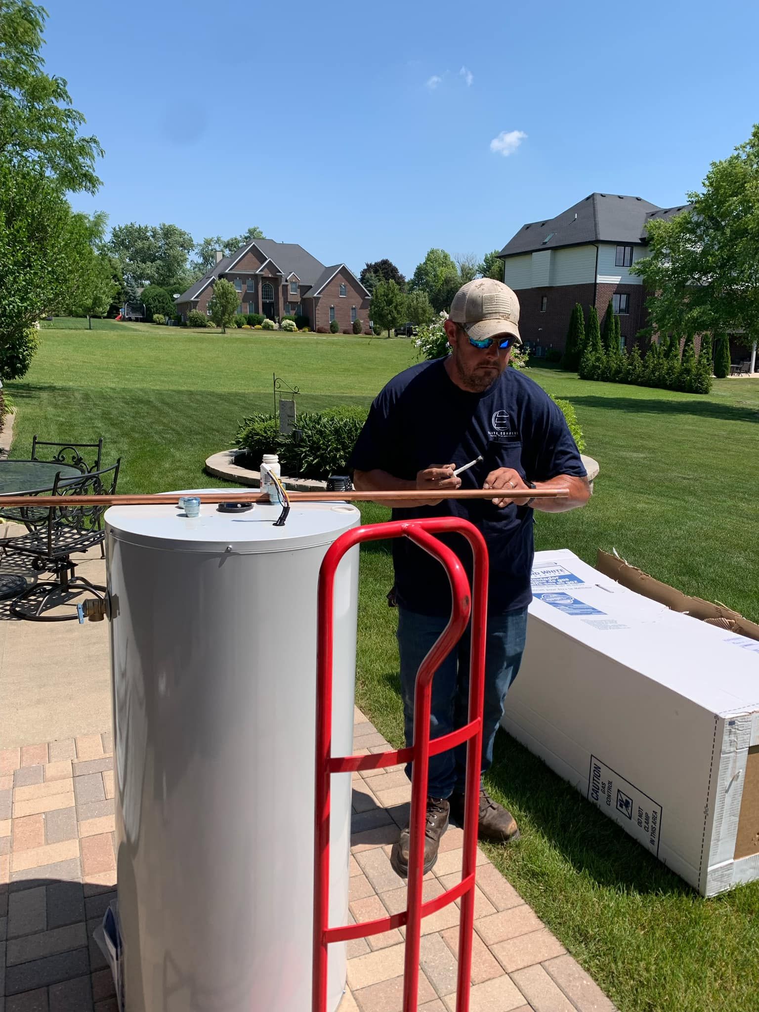 Man Is Working On Pipe System - Saint John, IN - Elite Comfort Heating And Air Conditioning LLC