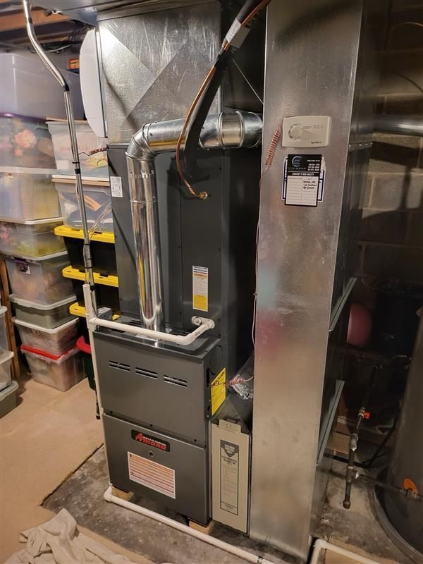 Person Is Fixing Water Heater - Saint John, IN - Elite Comfort Heating And Air Conditioning LLC