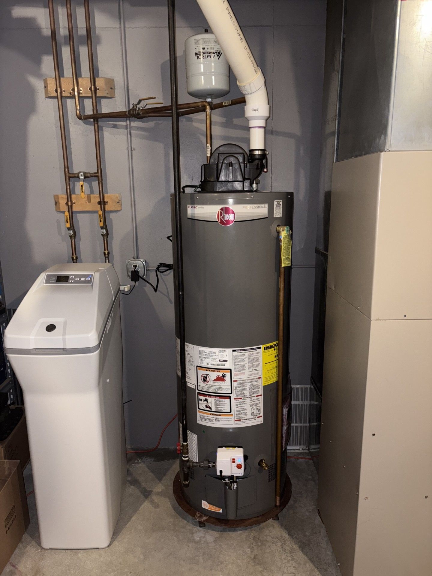Person Is Fixing Water Heater - Saint John, IN - Elite Comfort Heating And Air Conditioning LLC