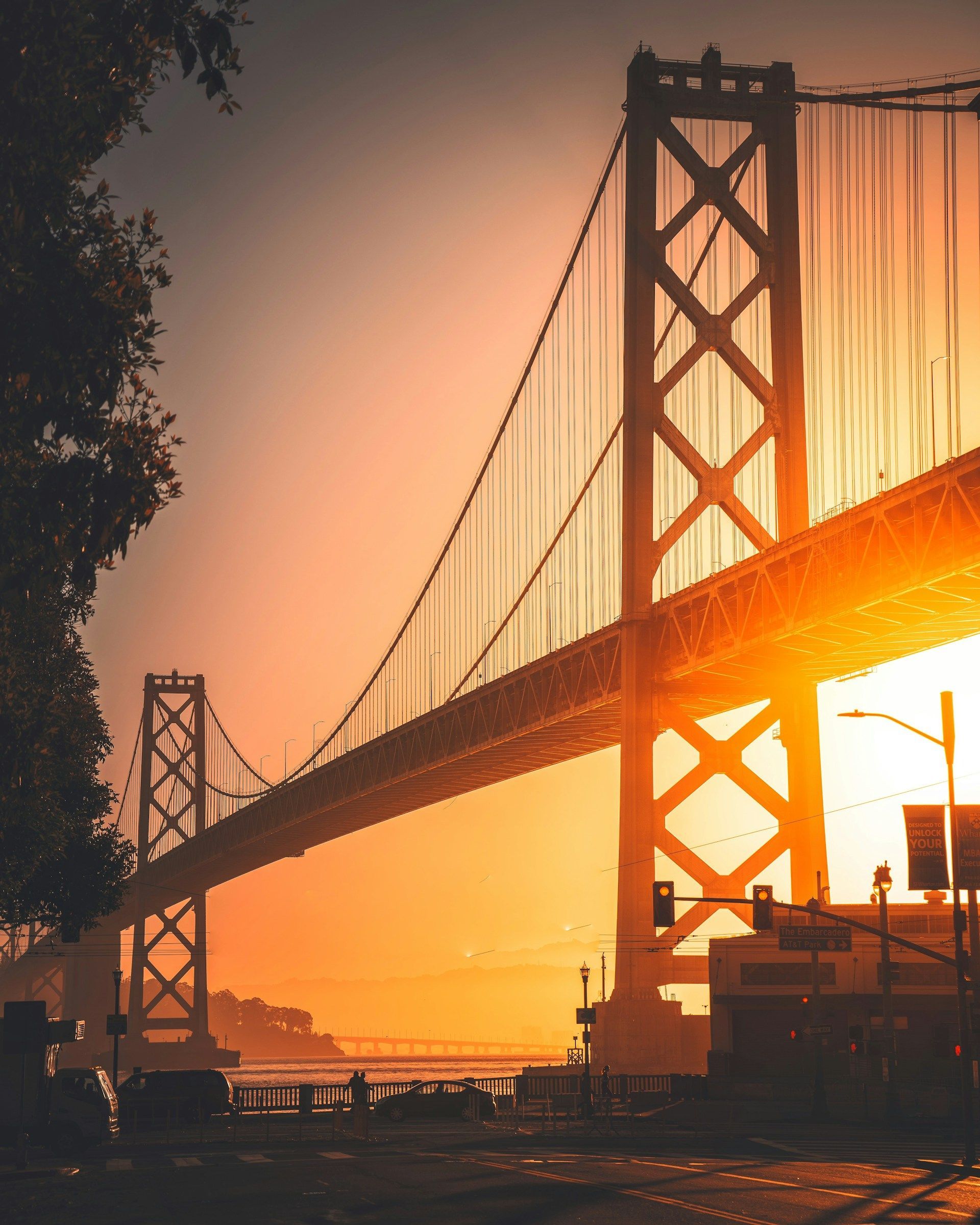 A bridge over a body of water at sunset