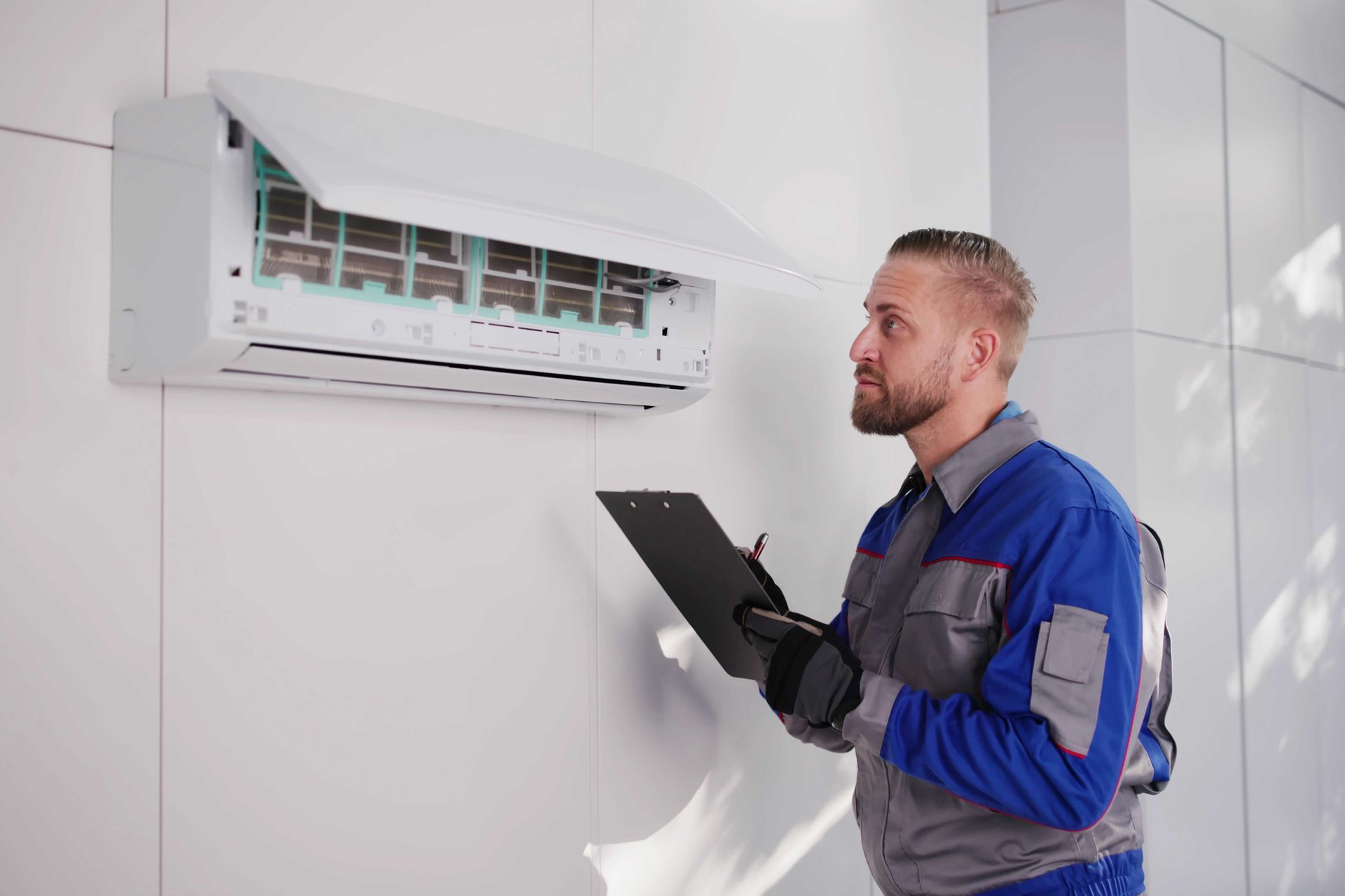 HVAC technician inspecting an air conditioner unit with a clipboard.