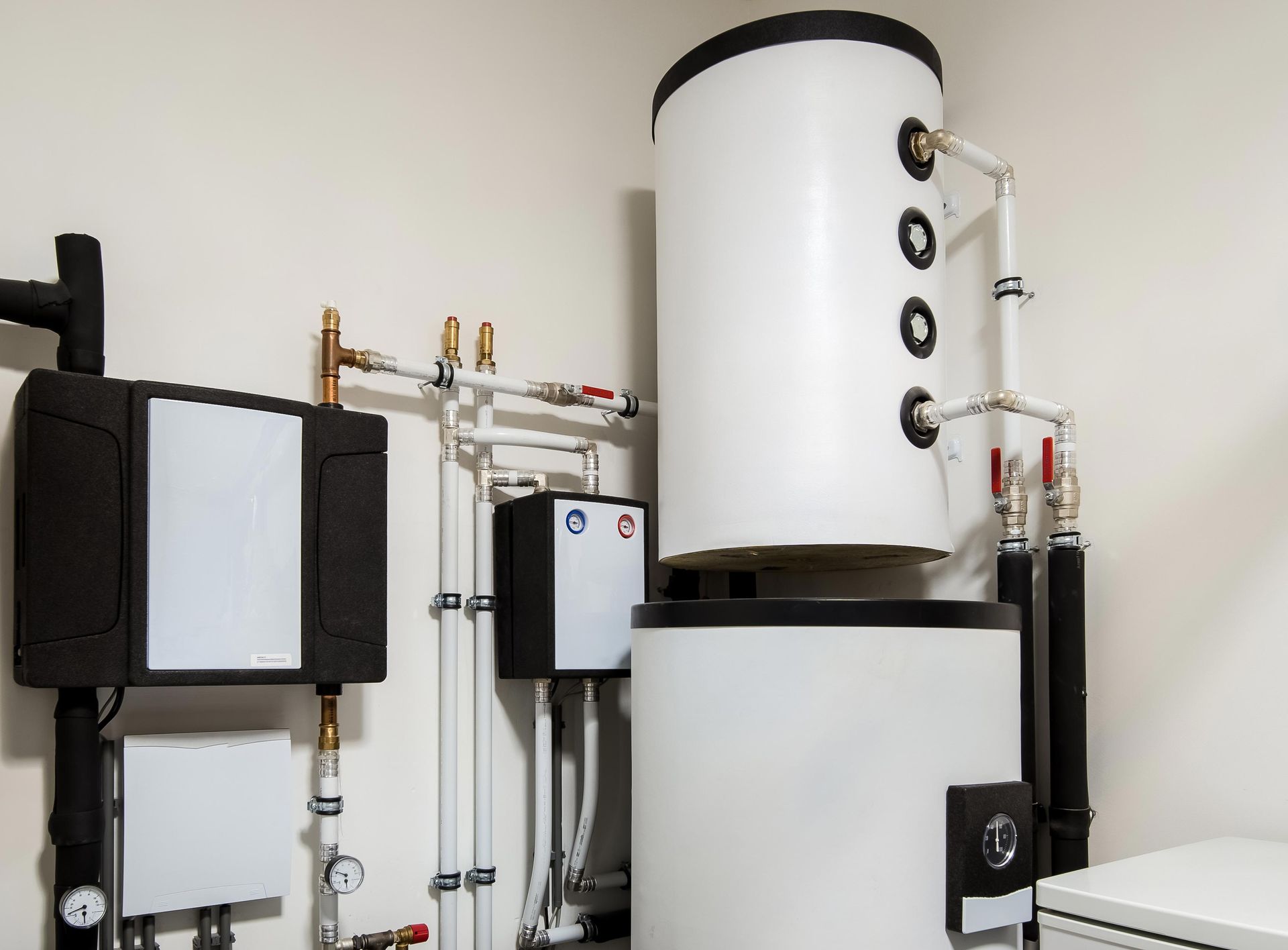 White water heater and related plumbing in an utility room.