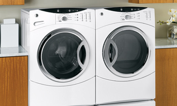 A washer and dryer are sitting next to each other in a laundry room.