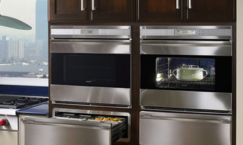 A kitchen with stainless steel appliances including a microwave oven