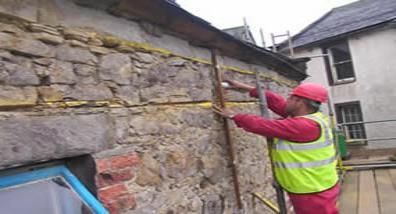 A semi truck is carrying a large excavator on a trailer.