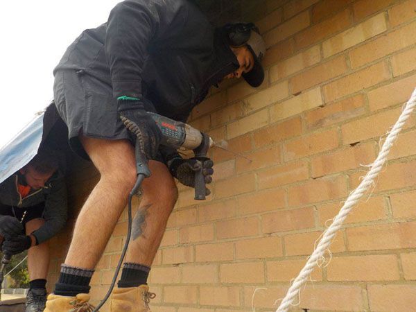 A semi truck is carrying a large excavator on a trailer.
