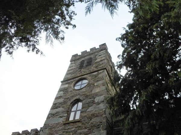 A semi truck is carrying a large excavator on a trailer.