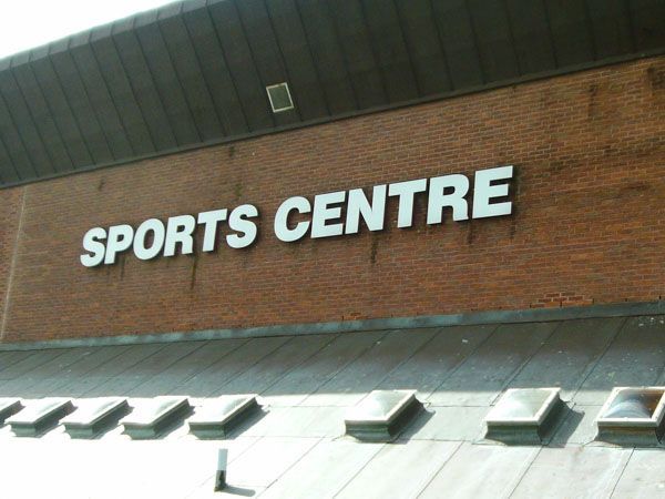 A semi truck is carrying a large excavator on a trailer.