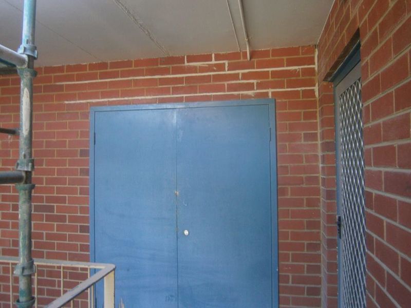 A semi truck is carrying a large excavator on a trailer.