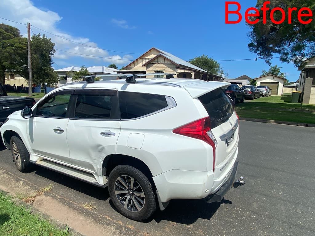 White SUV With Damaged Wheel Arch — Car Restoration in Taree, NSW