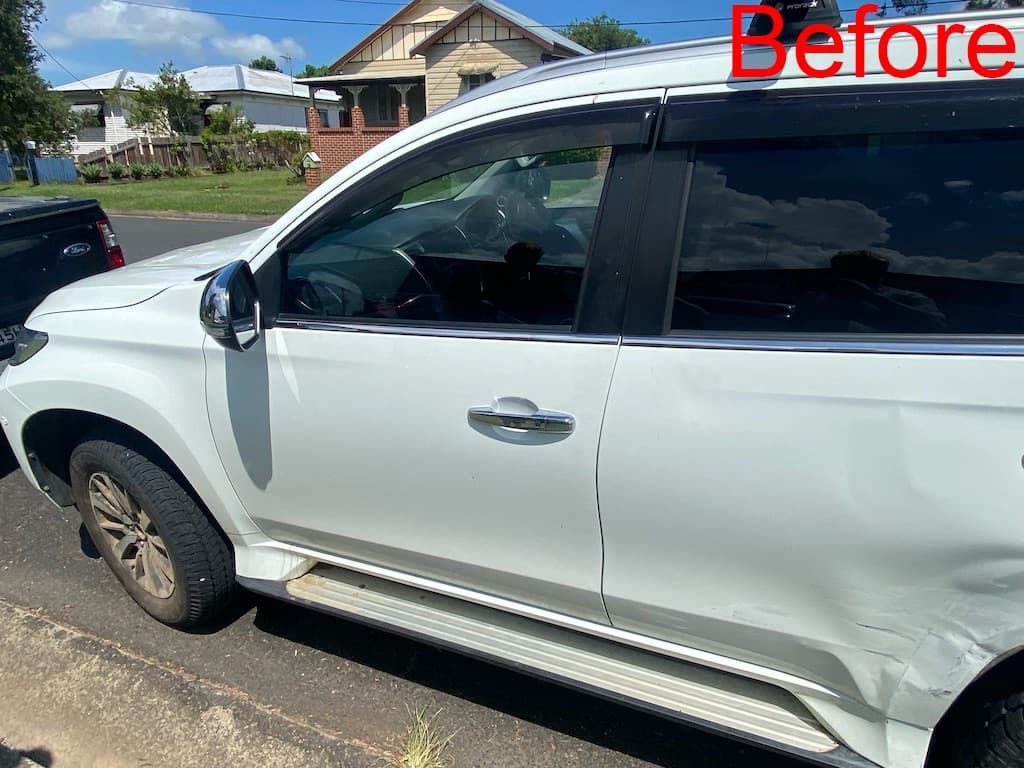 White Car With Large Dents in the Rear Passenger Door — Car Restoration in Taree, NSW