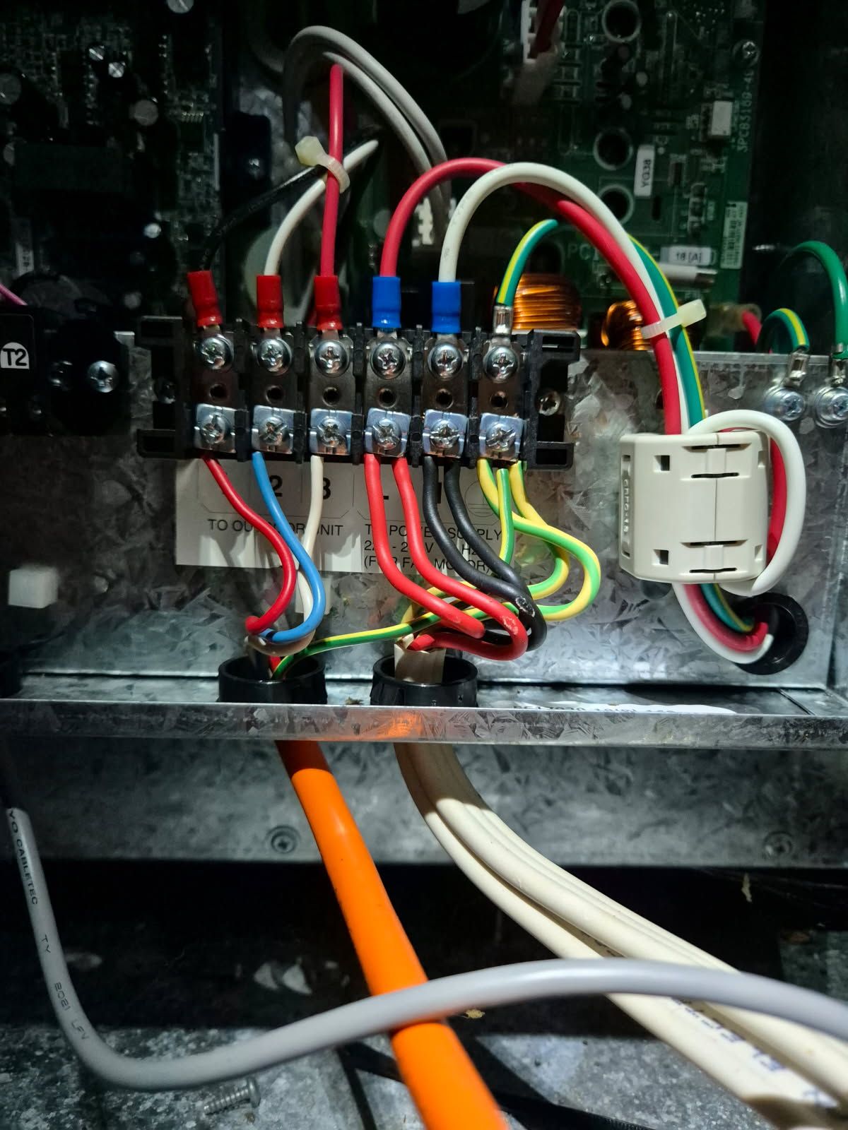 A Man is Working on an Electrical Box With a Pair of Pliers — Reilly Electrical Services in Yandina, QLD