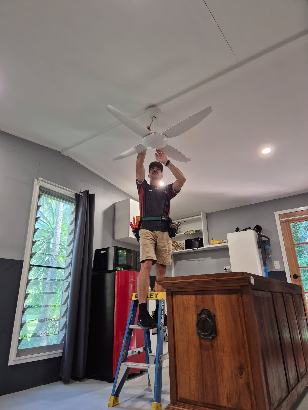 A Person is Fixing an Electric Meter With a Screwdriver — Reilly Electrical Services in Yandina, QLD