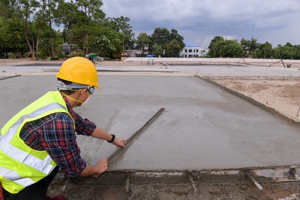 A Construction Worker is Laying Concrete on a Construction Site — Felto's Concrete Line Pumping in Corindi Beach, NSW