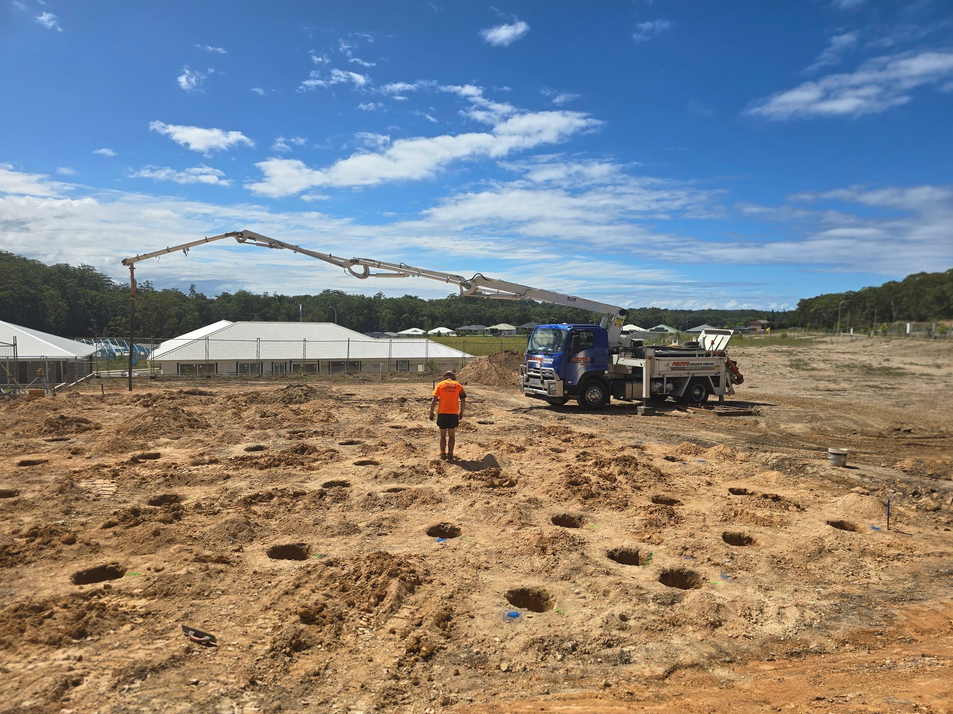 Felto’s boom pump working on a housing development site — Felto's Concrete Line Pumping in Coffs Harbour, NSW.
