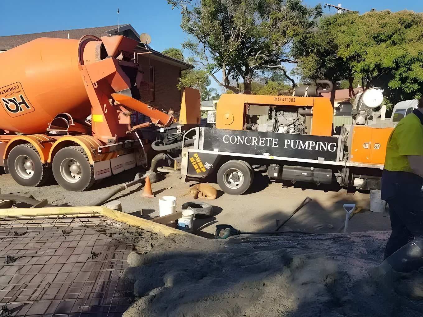 A Concrete Pumping Truck is Parked Next to a Mixer Truck — Felto's Concrete Line Pumping in Corindi Beach, NSW