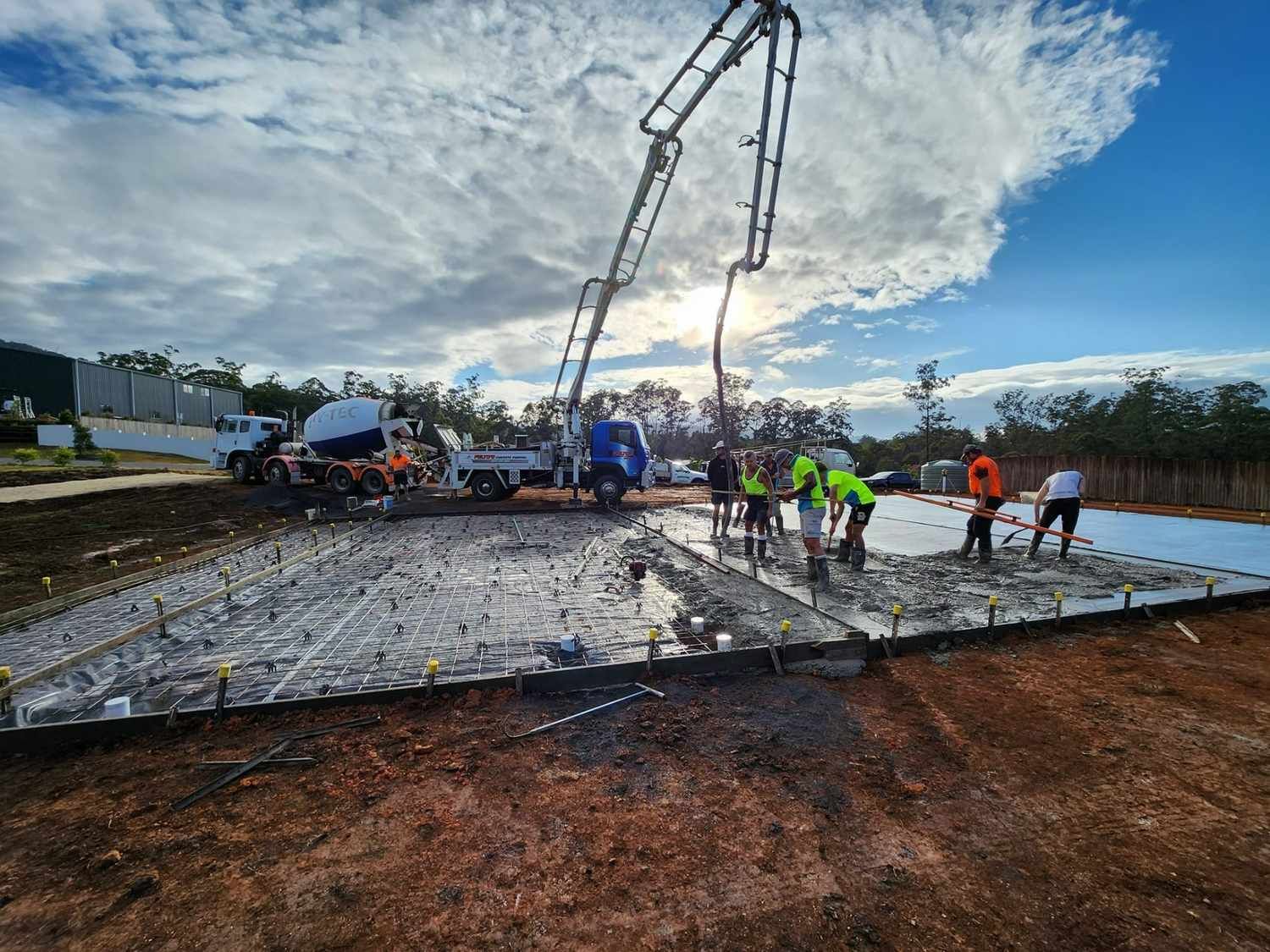 A Group of People Are Working on a Construction Site — Felto's Concrete Line Pumping in Coffs Harbour, NSW