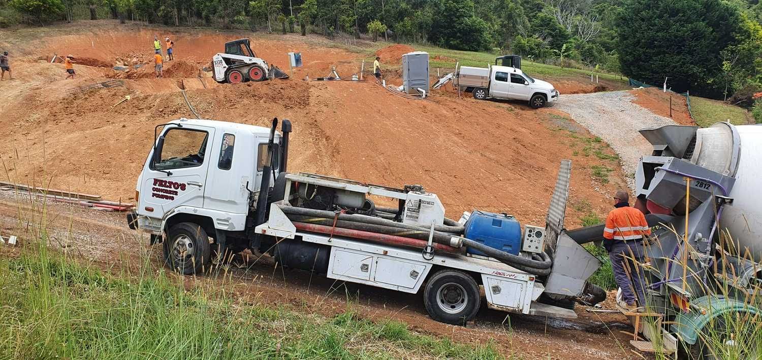 A White Truck is Parked on the Side of a Dirt Road — Felto's Concrete Line Pumping in Nambucca Heads, NSW