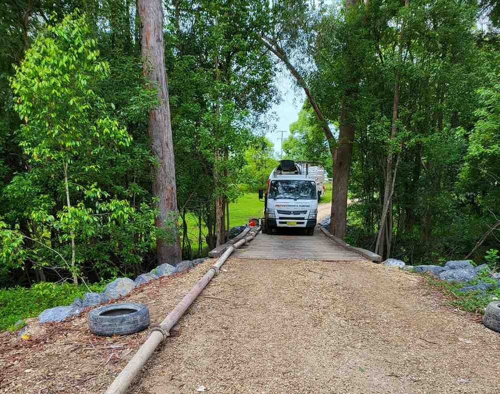 A Truck is Parked on the Side of a Gravel Road — Felto's Concrete Line Pumping in Coffs Harbour, NSW