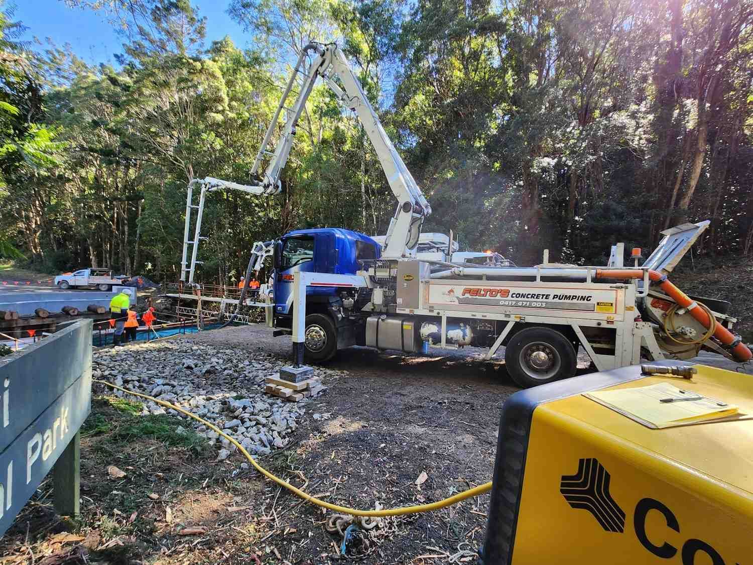 A Concrete Pump Truck is Being Used to Pump Concrete on a Road — Felto's Concrete Line Pumping in Macksville, NSW