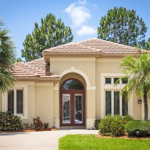 A house with palm trees and a driveway — Windemere, FL — Valor Homes Construction LLC