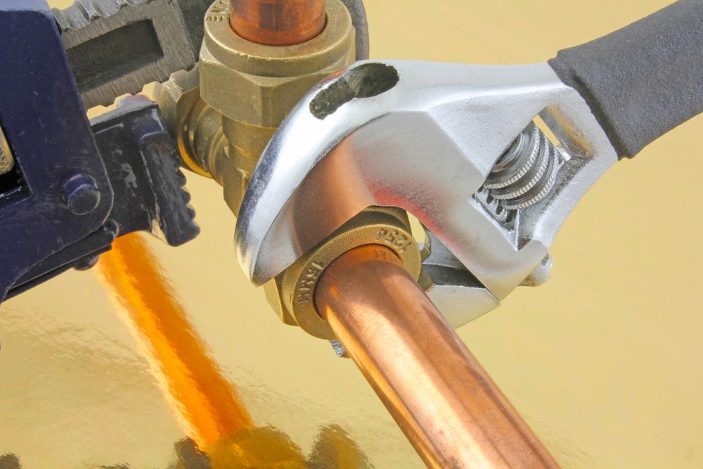 A Wrench Tightening a Fitting on Copper Pipes — David McNeill Plumma (Gas Specialist) In Cessnock, NSW