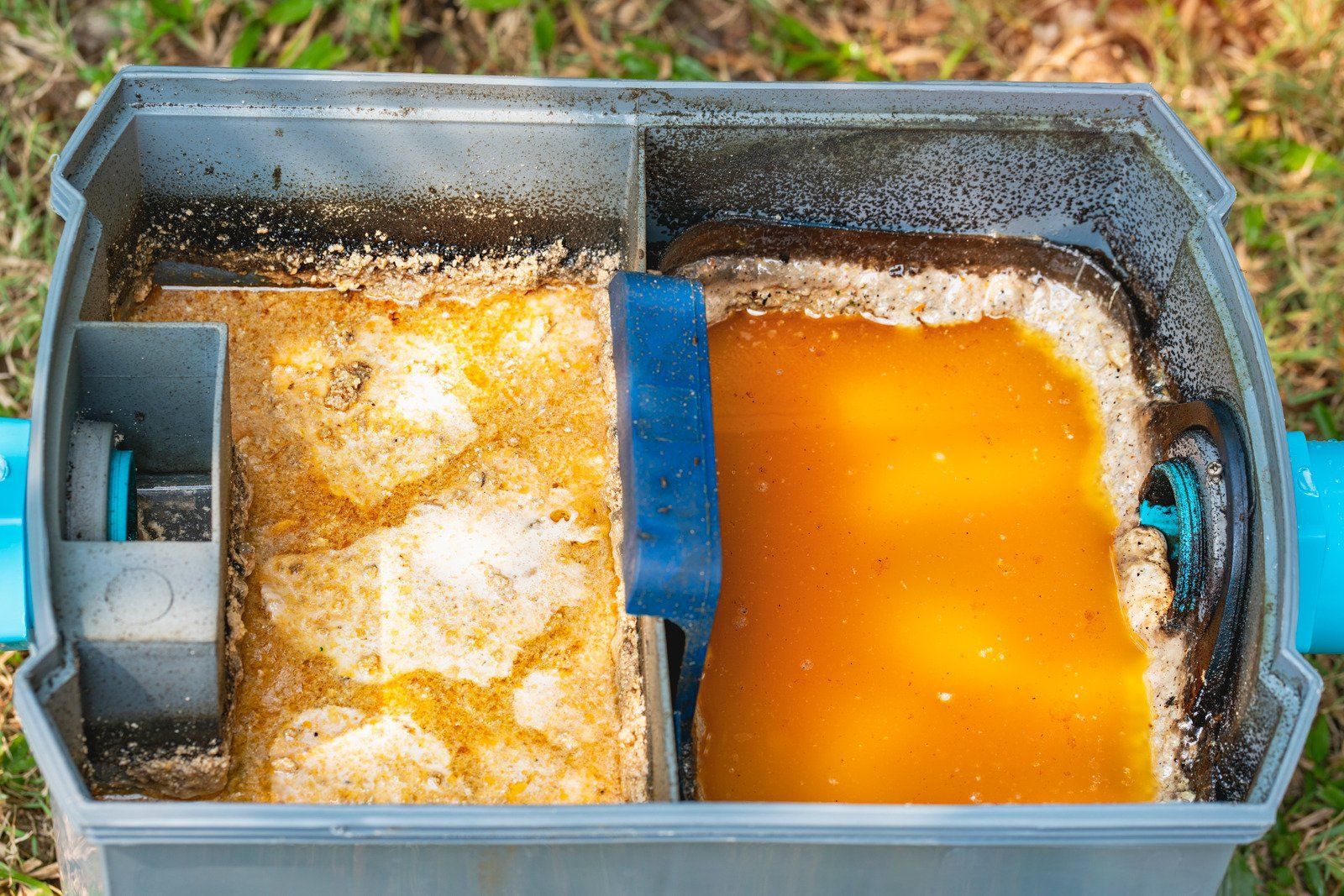 A close up of a septic tank with a sponge in it.