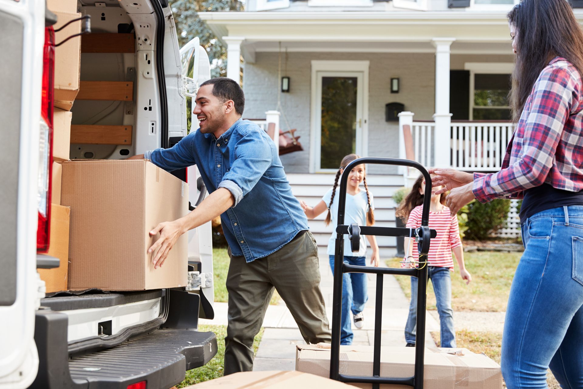 a family is loading boxes into a moving van.
