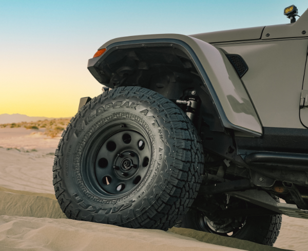 Gray Jeep Tire on a Sandy Dune — Cairns Tyre Specialists In Cairns City, QLD