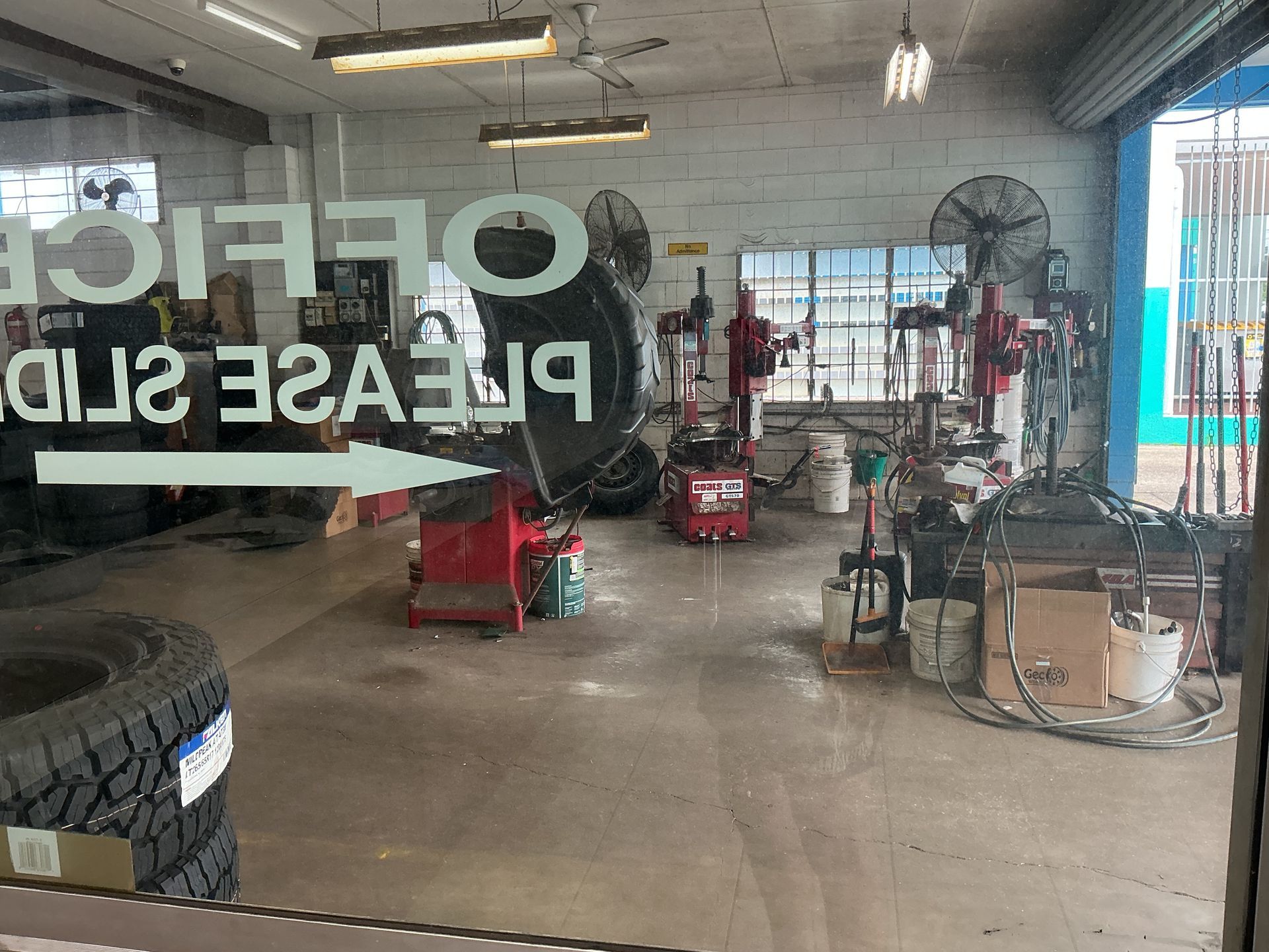 Inside a Garage With Tire-changing Equipment — Cairns Tyre Specialists In Cairns City, QLD