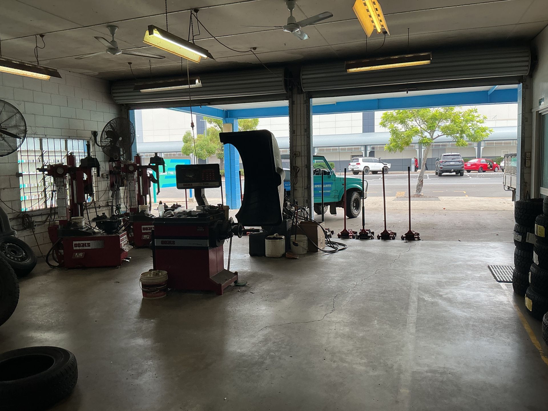 Inside of a Tire Shop With Open Garage Door  — Cairns Tyre Specialists In Cairns City, QLD