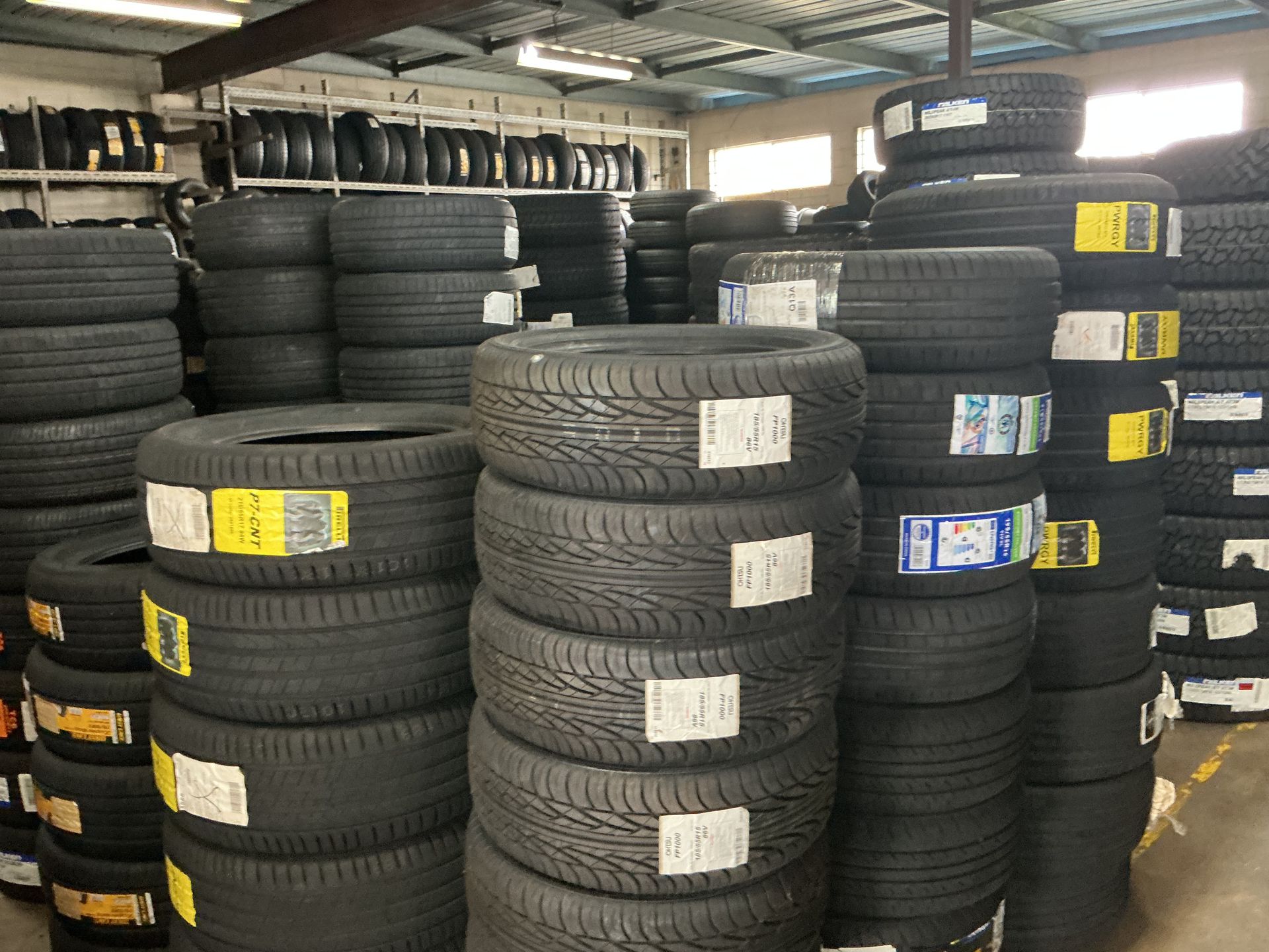 Tires Stacked in a Warehouse — Cairns Tyre Specialists In Cairns City, QLD