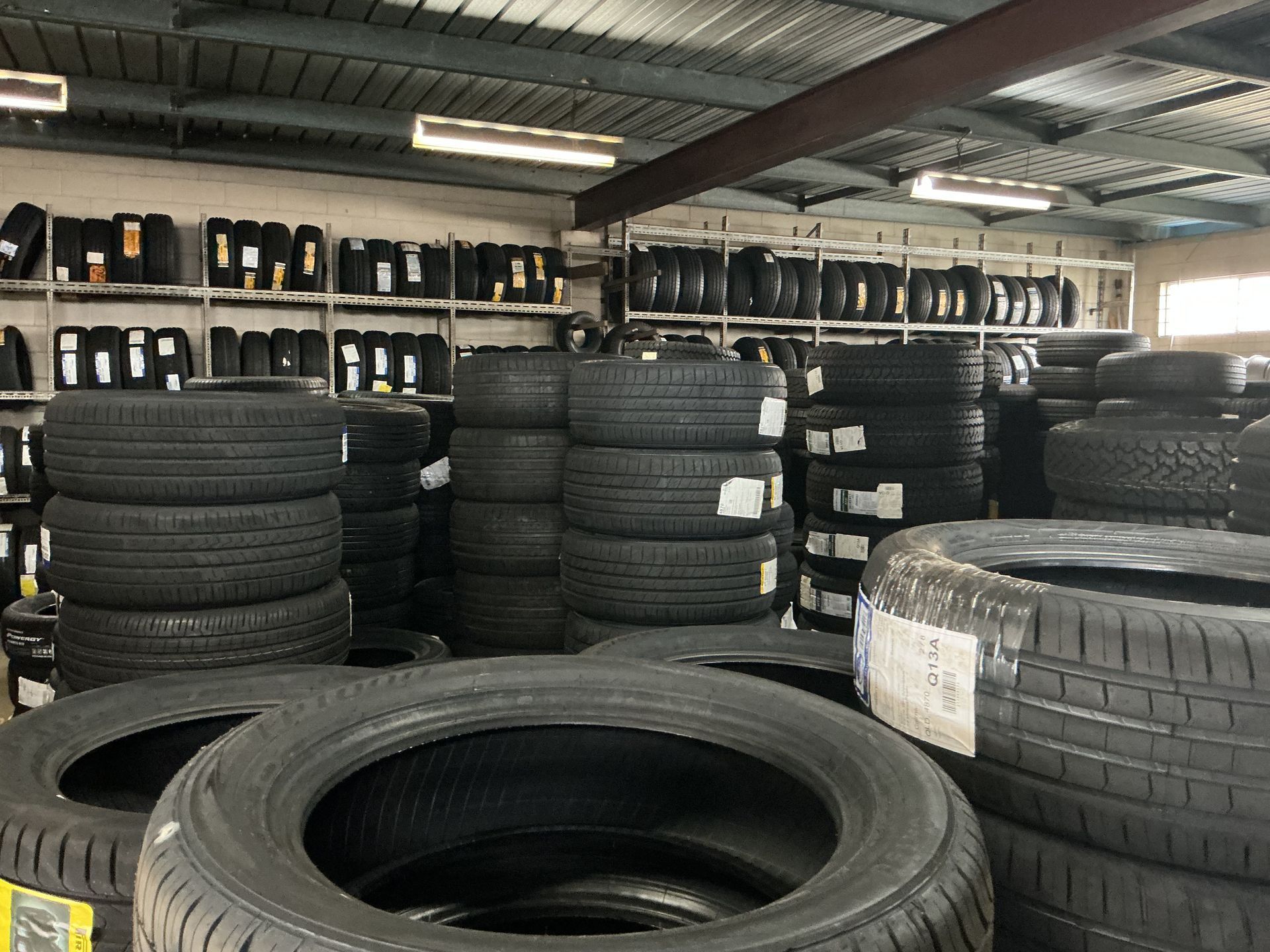 Tires Stacked in a Warehouse Setting — Cairns Tyre Specialists In Cairns City, QLD