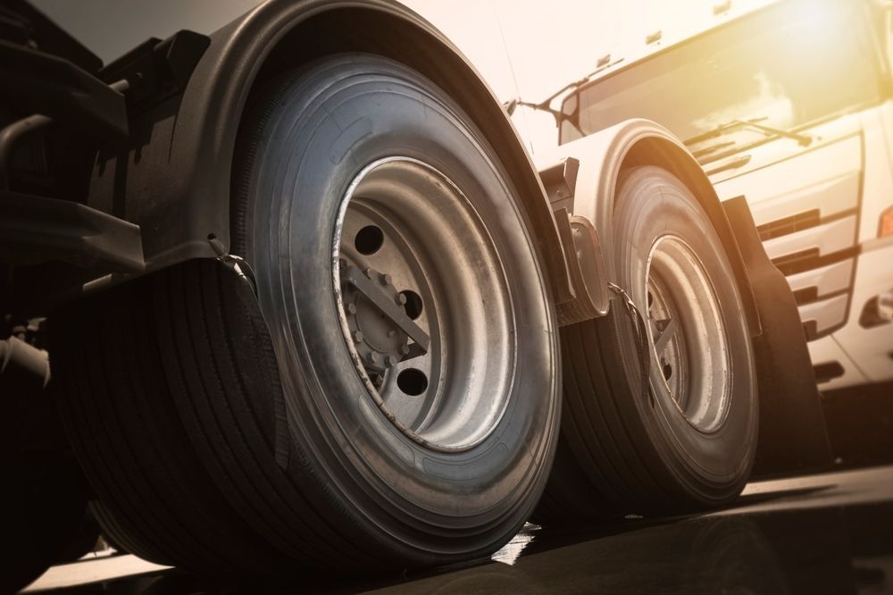 Close-up of Two Truck Tires With Metallic Rims, Set Against a Bright Sky — Cairns Tyre Specialists In Cairns City, QLD