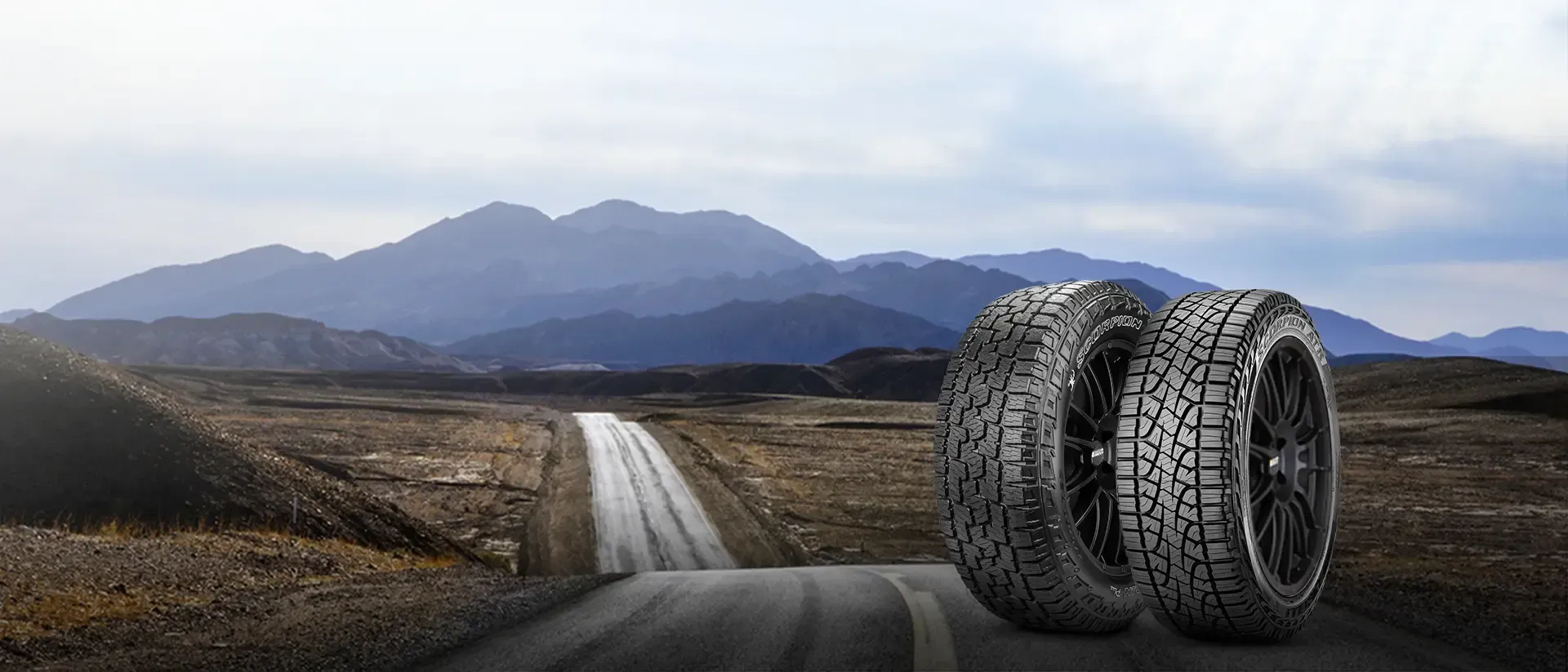 Two Tires on a Road, With a Mountain Range in the Background — Cairns Tyre Specialists In Cairns City, QLD