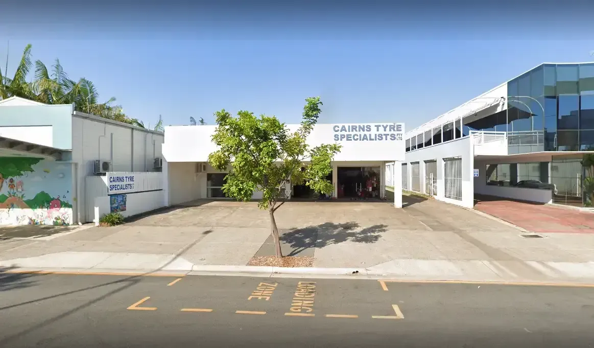 Mechanic Working on a Tire in a Garage, Using Equipment — Cairns Tyre Specialists In Cairns City, QLD