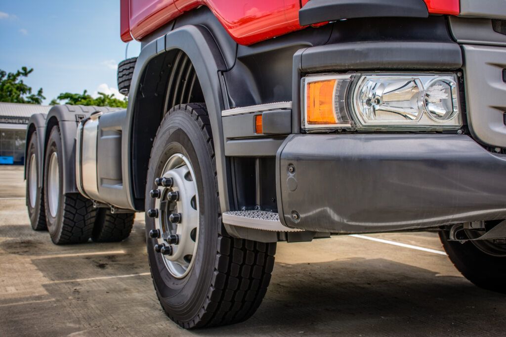 Close-up of a Red Semi-truck Cab and Wheels on a Paved Surface — Cairns Tyre Specialists In Cairns City, QLD