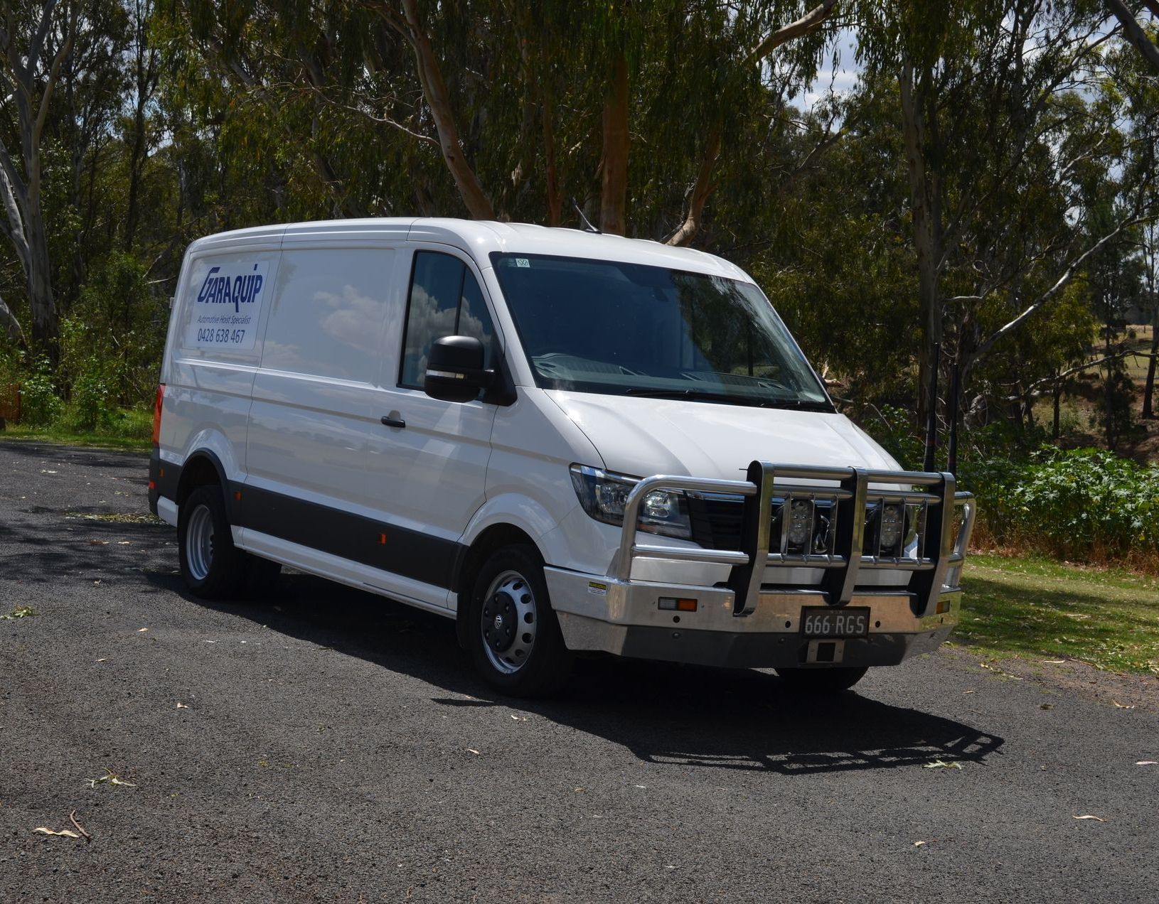 White Garaquip Mobile Van Parked Outside Having Trees Behind — Hoist Installation Near Dubbo