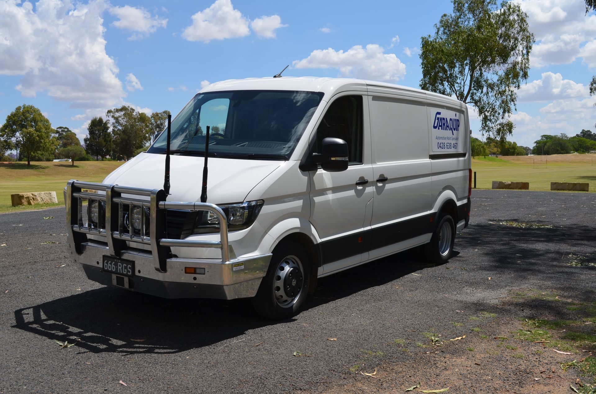 Garaquip White Van With two Antennas On Front Parked Outside — Vehicle Hoist Near Dubbo