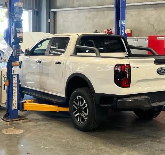 Red Car at Repair Station — Vehicle Hoist Near Dubbo