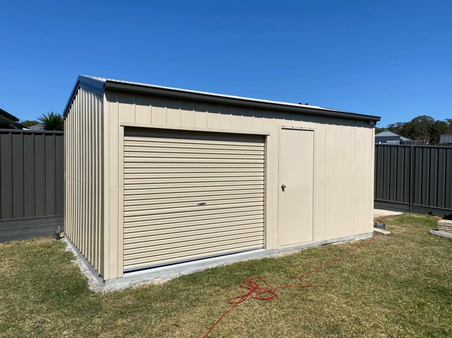 Interior of A Metal Farm Shed Filled with Tractors and Farm Equipment — Fair Dinkum Builds Port Stephens in Bobs Farm, NSW