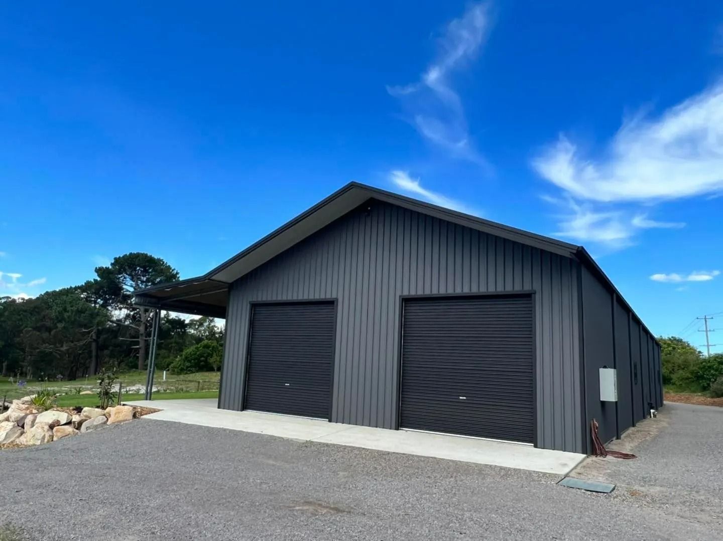 Dark Gray Metal Garage with Two Bays, Set Against a Blue Sky — Fair Dinkum Builds Port Stephens in Bobs Farm, NSW