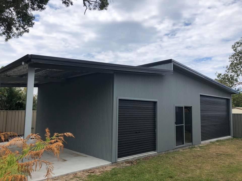 Gray Metal Shed with A Carport, Black Roller Doors — Fair Dinkum Builds Port Stephens in Bobs Farm, NSW