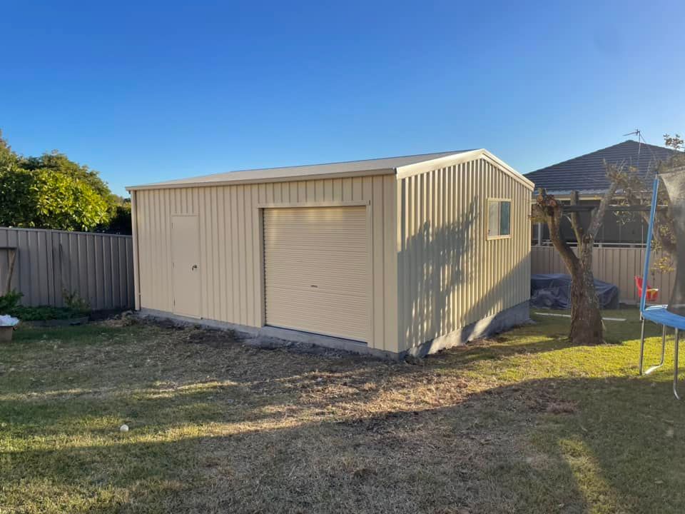 Tan Metal Shed with A Roller Door and Side Door — Fair Dinkum Builds Port Stephens in Bobs Farm, NSW