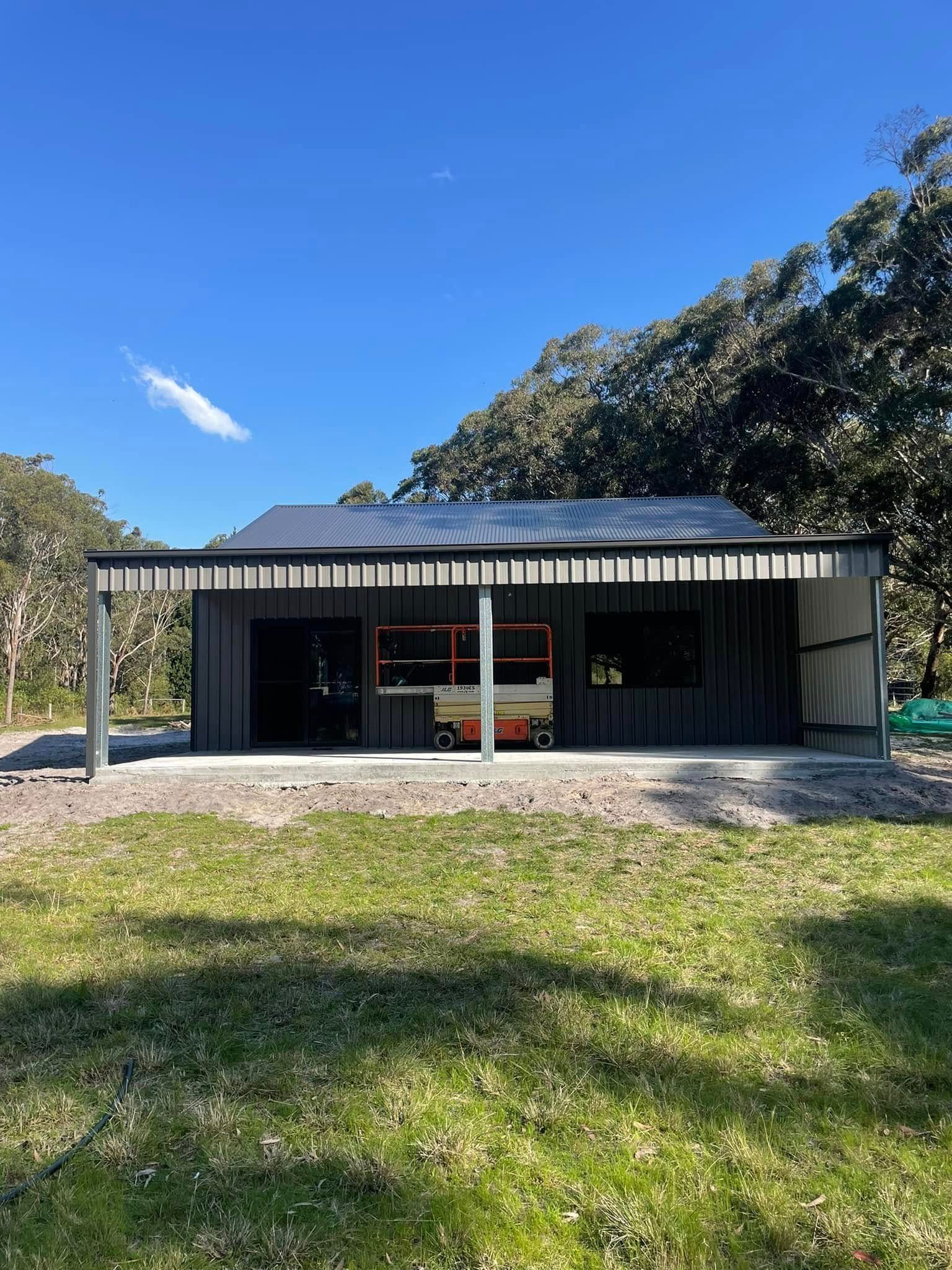 Dark Gray Shed with An Open Awning, Parked Forklift Inside — Fair Dinkum Builds Port Stephens in Bobs Farm, NSW