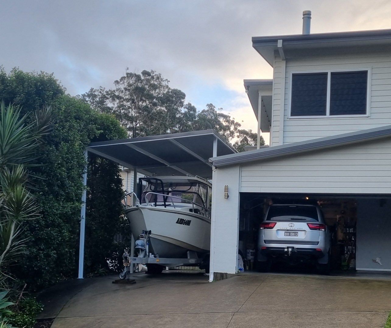 Boat on A Trailer Under a Carport Next to A House — Fair Dinkum Builds Port Stephens in Hunter Valley, NSW